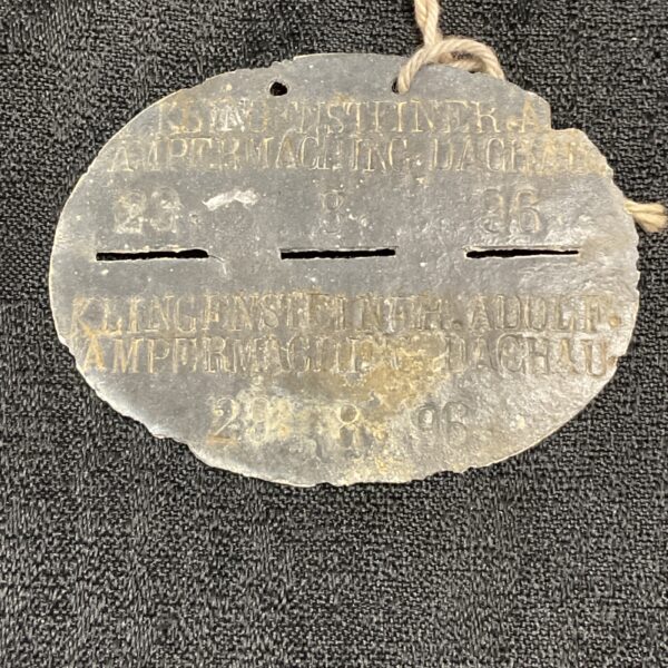 Vintage zinc German dog tag with embossed lettering.
