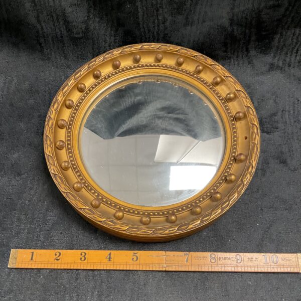 Antique gilt convex butler mirror with radiating frame.