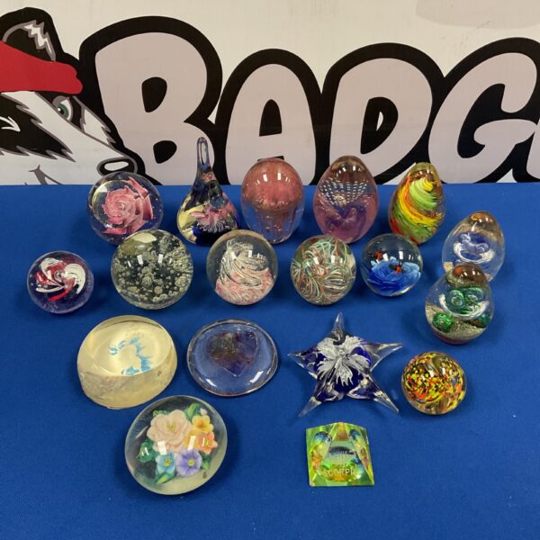 Colorful glass paperweight collection for desk display.