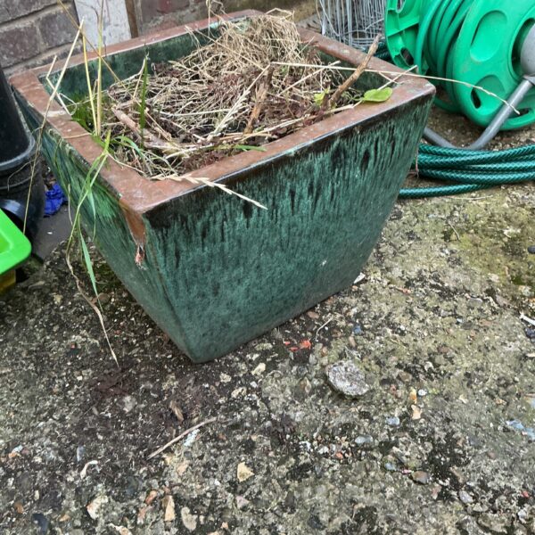 Vintage glazed garden planter with a green mottled finish.