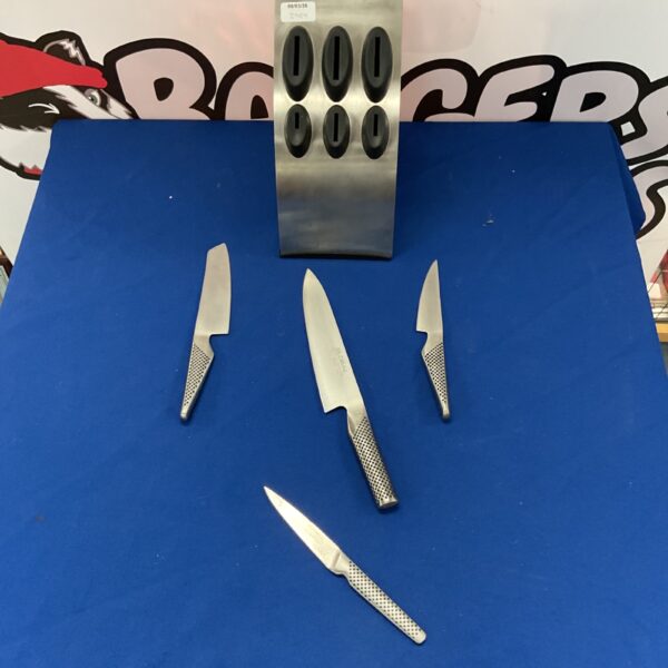 Global kitchen knife set on a stand, stainless steel cutlery.