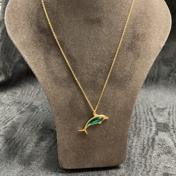 Gold dolphin pendant necklace on a chain.