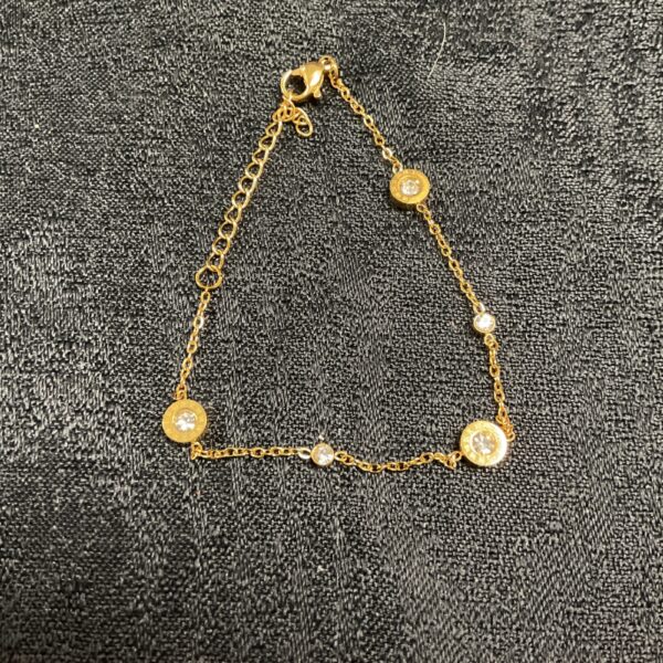 Delicate gold plated bracelet with a white stone setting.