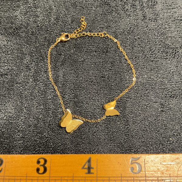Delicate gold plated butterfly bracelet, a charming fashion accessory.