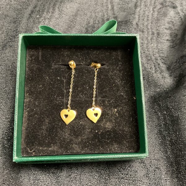 Elegant gold plated heart drop earrings on a boxed display.