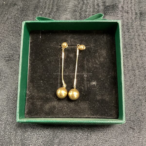 Gold plated stud earrings in a green box.