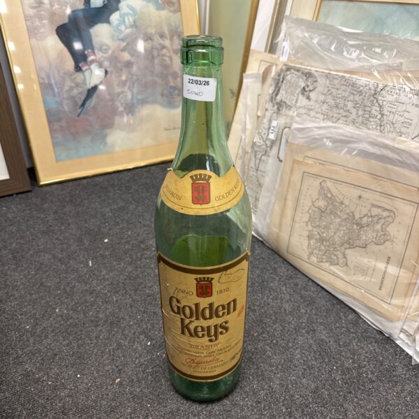 Vintage Golden Keys Brandy bottle with coin saver feature.