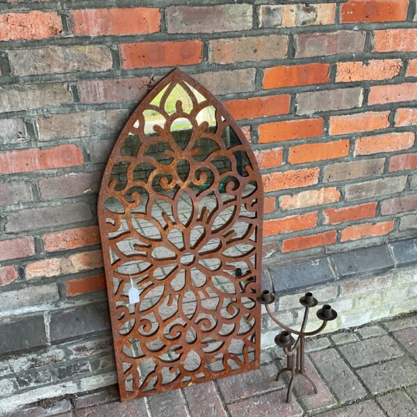 Weathered metal gothic garden mirror with candelabra for outdoor display.