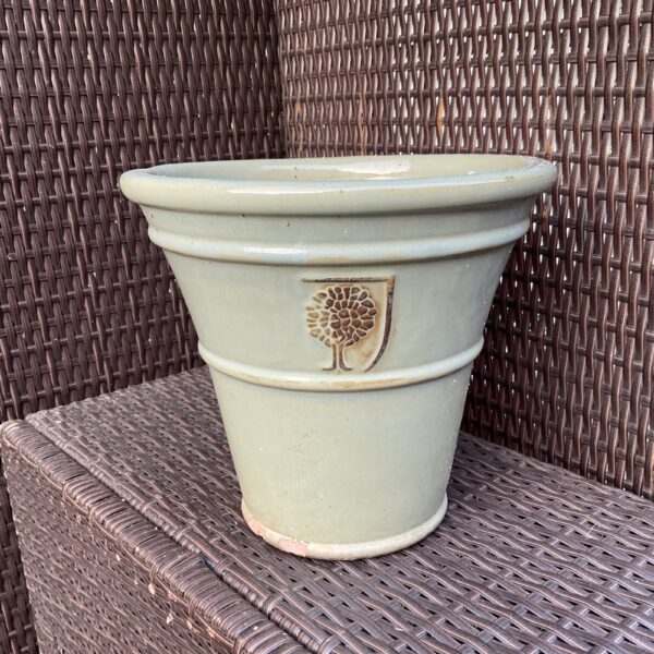 Green glazed ceramic plant pot for garden display.