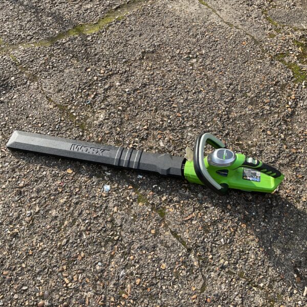 Greenworks cordless strimmer for garden maintenance.
