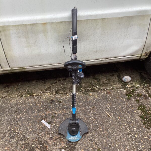 Used Gtech Rapid Blade Pro cordless strimmer for garden maintenance.