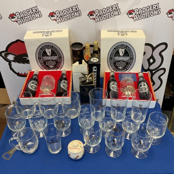 Large collection of Guinness glasses and bottles for collectors.