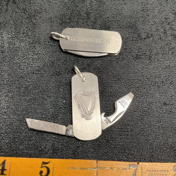 Vintage Guinness keyring penknife with harp emblem.