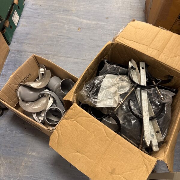 Mixed lot of used PVC gutter fittings for rainwater drainage.