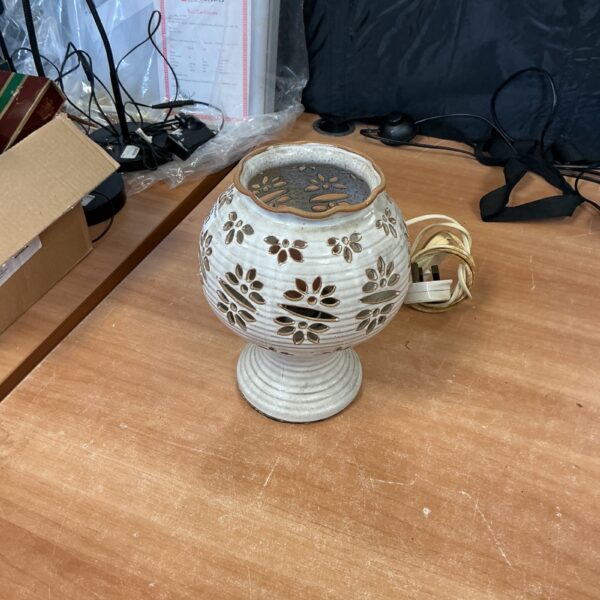 Handcrafted glazed ceramic lamp with floral detailing.