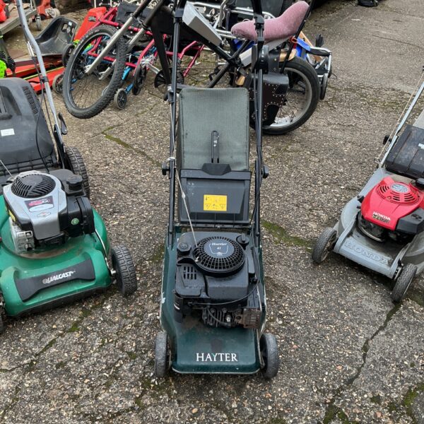 Used Hayter Harrier 41 petrol lawn mower in a garden setting.