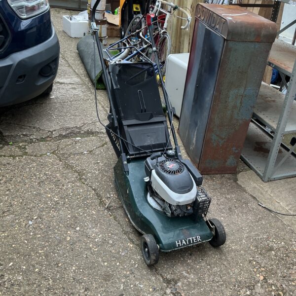 Used Hayter petrol lawnmower in a garden setting.