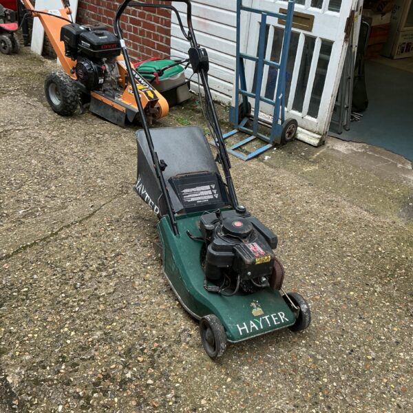 Vintage Hayter lawnmower in a garden setting.