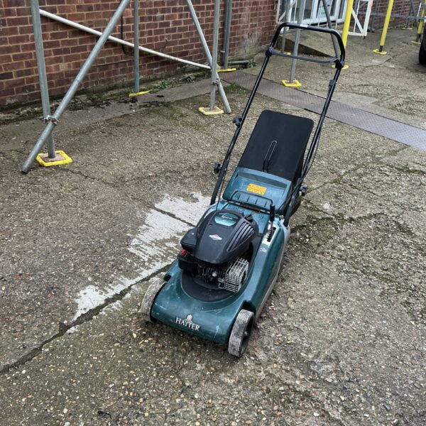 Used Hayter Spirit 41 petrol lawnmower in garden setting.