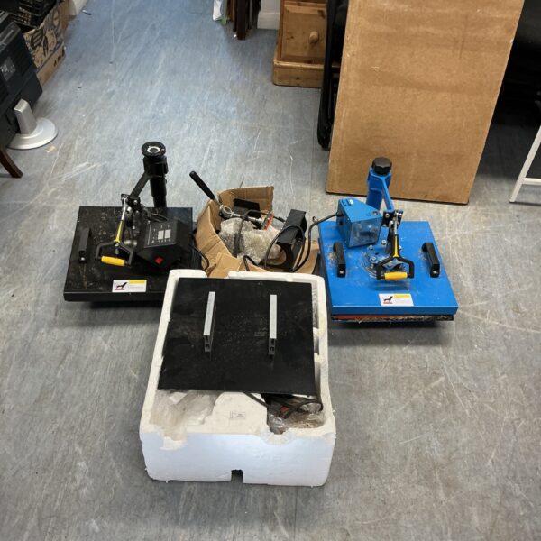 Two heat press machines in an untested lot for crafting.