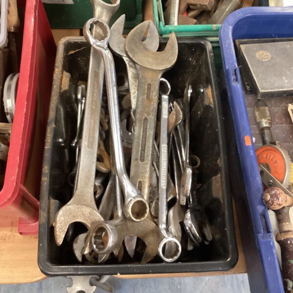 Assorted heavy-duty spanners in a tool box.