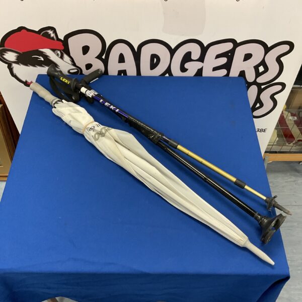 Two hiking walking sticks, one Leki brand, and an umbrella stick.
