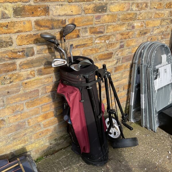 Hippo golf set with trolley and clubs on a paved surface.