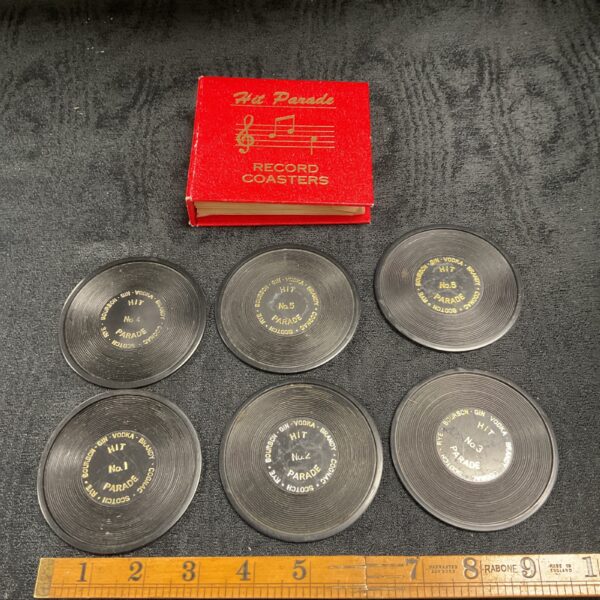 Vintage Hit Parade record coaster set with red labels.