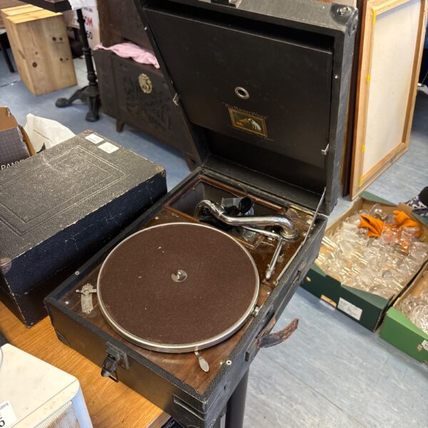 Vintage HMV gramophone with wooden cabinet and metal horn.