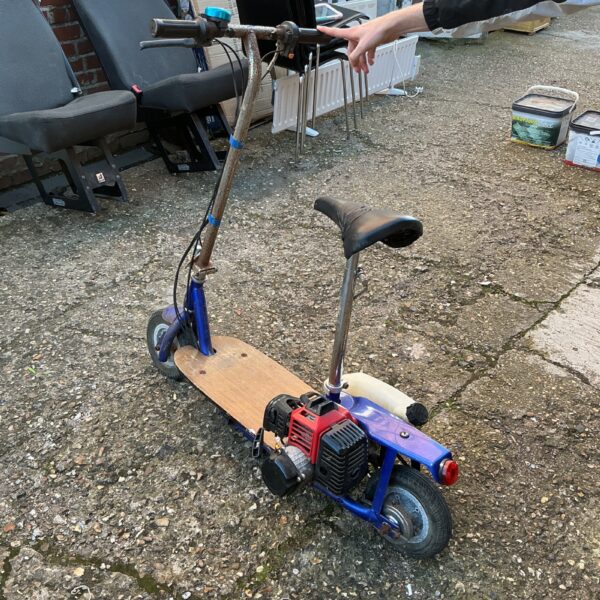 Side view of a unique homemade petrol scooter.