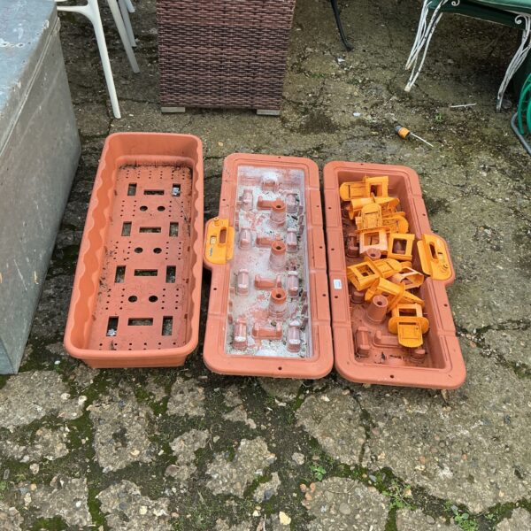 Hozelock greenhouse irrigation system components laid out for sale.