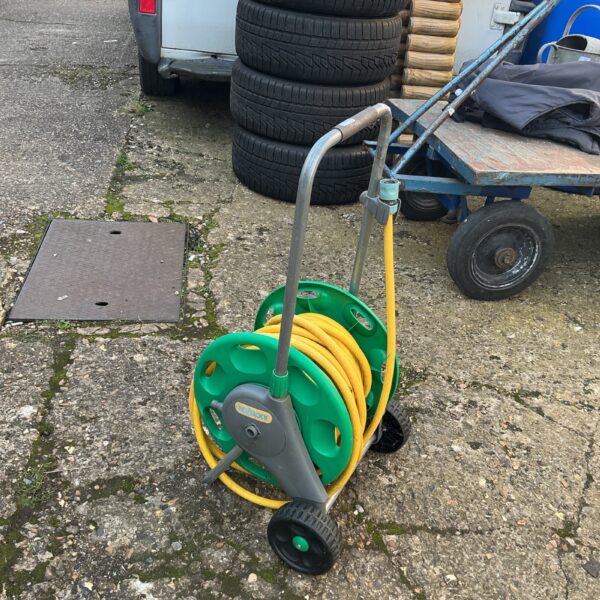 Green and black Hozlock garden hose reel with a wound hose.