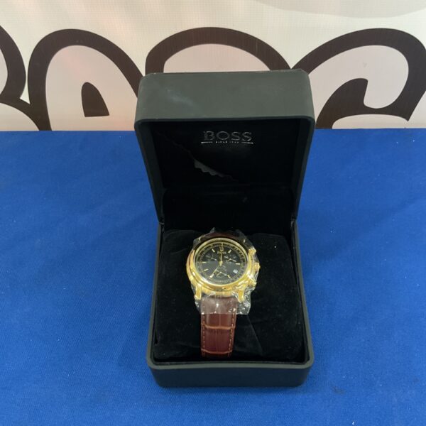 Gold-tone Hugo Boss wristwatch with brown strap.