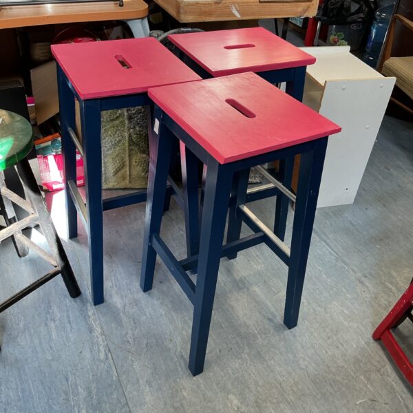 Three painted IKEA stools with a rustic finish.