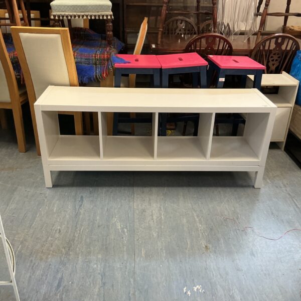 White IKEA side unit with open shelving for storage.