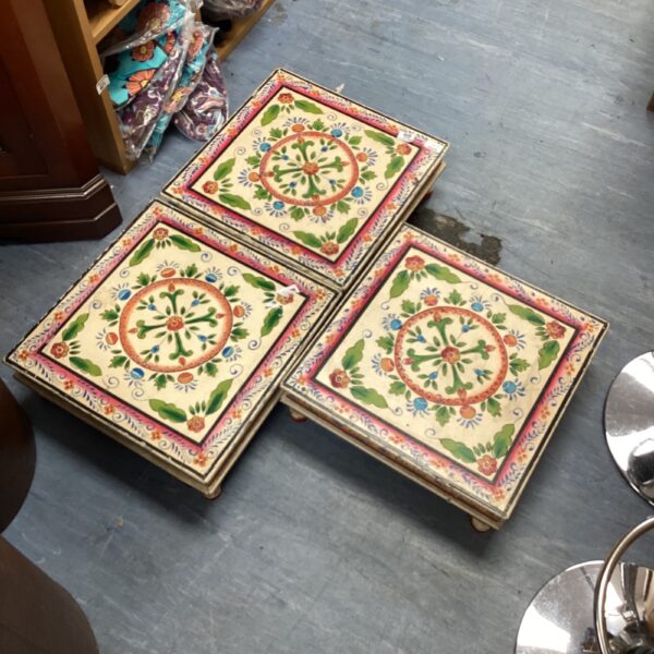 Set of three vibrant hand-painted Indian decorative tables.