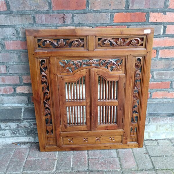 Intricate Indonesian carved mahogany mirror with doors.