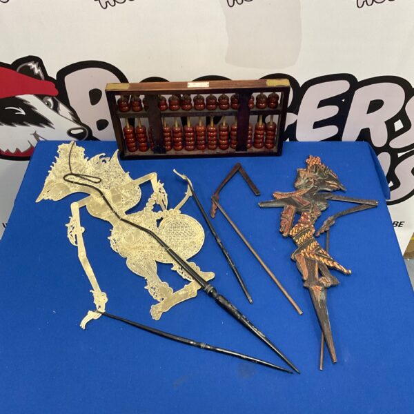 Indonesian shadow puppets and red lion abacus, traditional Javanese art.
