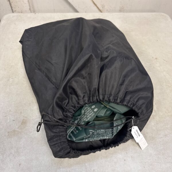 Deflated inflatable single bed for camping or temporary use.