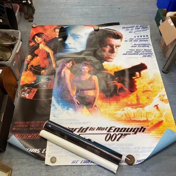 Large James Bond 007 cinema lobby posters and One Direction poster.