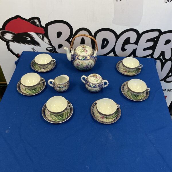 Vintage Japanese china tea set with floral designs.