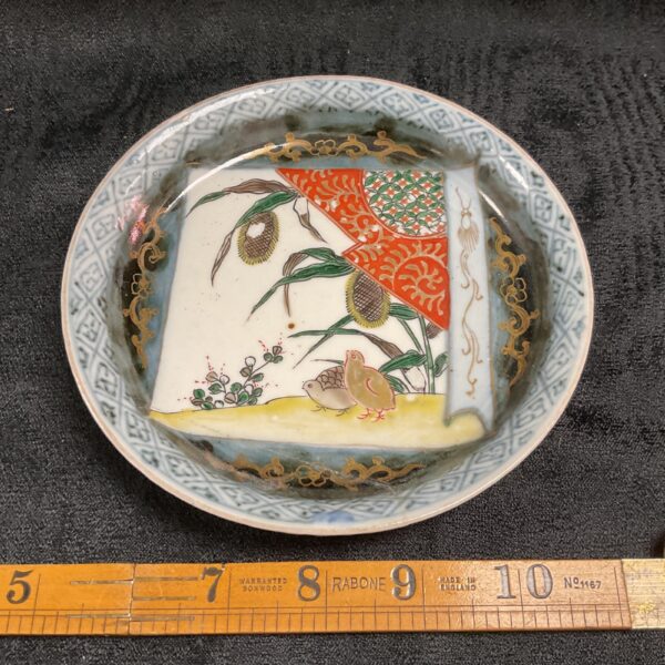 Antique Japanese Imari porcelain dish with hand-painted bird scene.