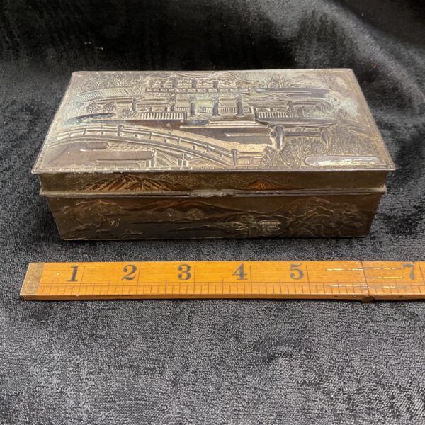 Intricate silverplated Japanese jewellery box with landscape relief carving.