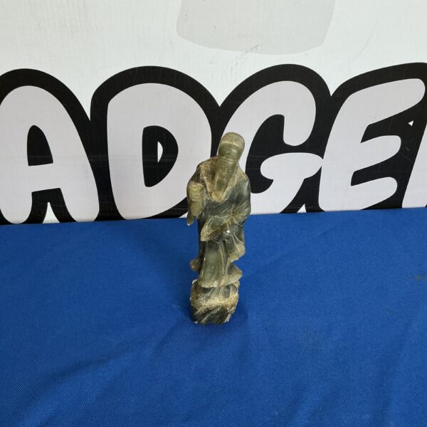 Detailed Japanese soapstone figurine of a seated figure.
