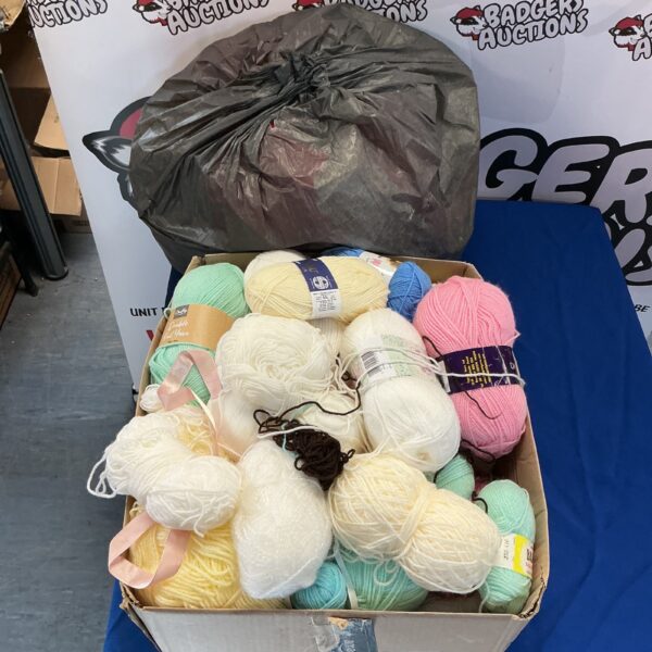 Mixed colours of knitting wool in a box and bag.