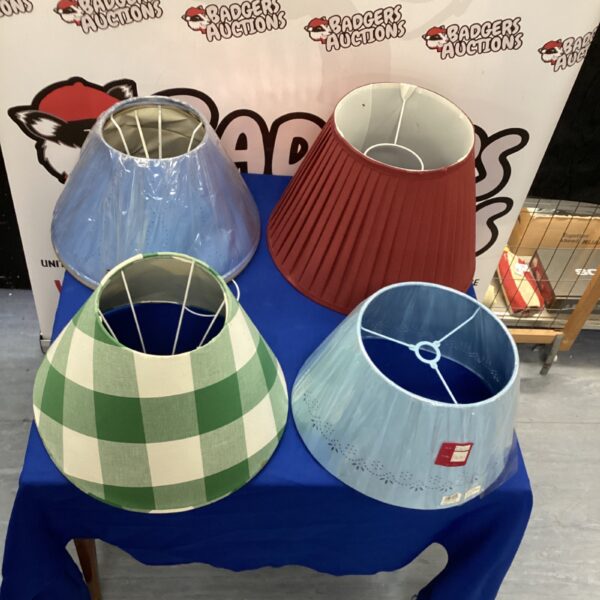 Assorted fabric lamp shades in a bundle for home lighting.