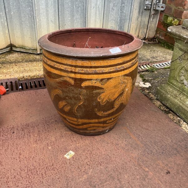 Large ceramic garden pot with weathered terracotta finish.