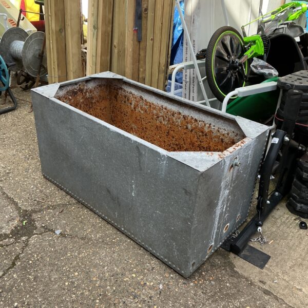 Large galvanised water tank for outdoor storage and collection.