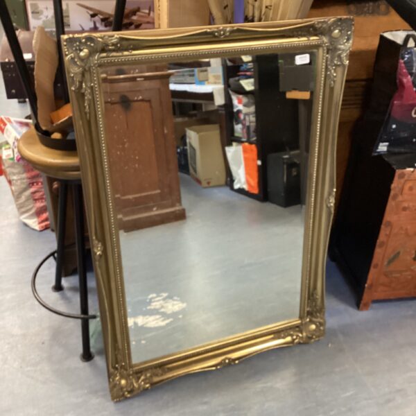 Ornate gilt framed mirror, antique style wall decor.