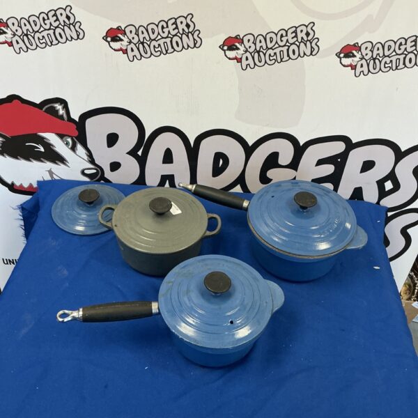 Vintage blue Le Creuset cast iron pans with lids.